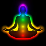 7 chakras glowing in figure in meditation pose