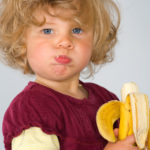 homeless girl eating banana -pouting but no voice