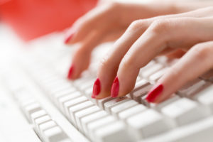 Woman's fingers typing with computer keyboard