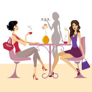 women talking about a project over coffee at a cafe table with waitress bringing food