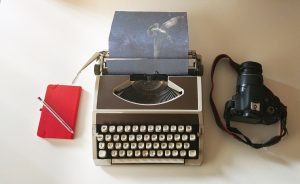 smart phone, typewriter, and camera for content creation