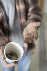 homeless man with cup for change